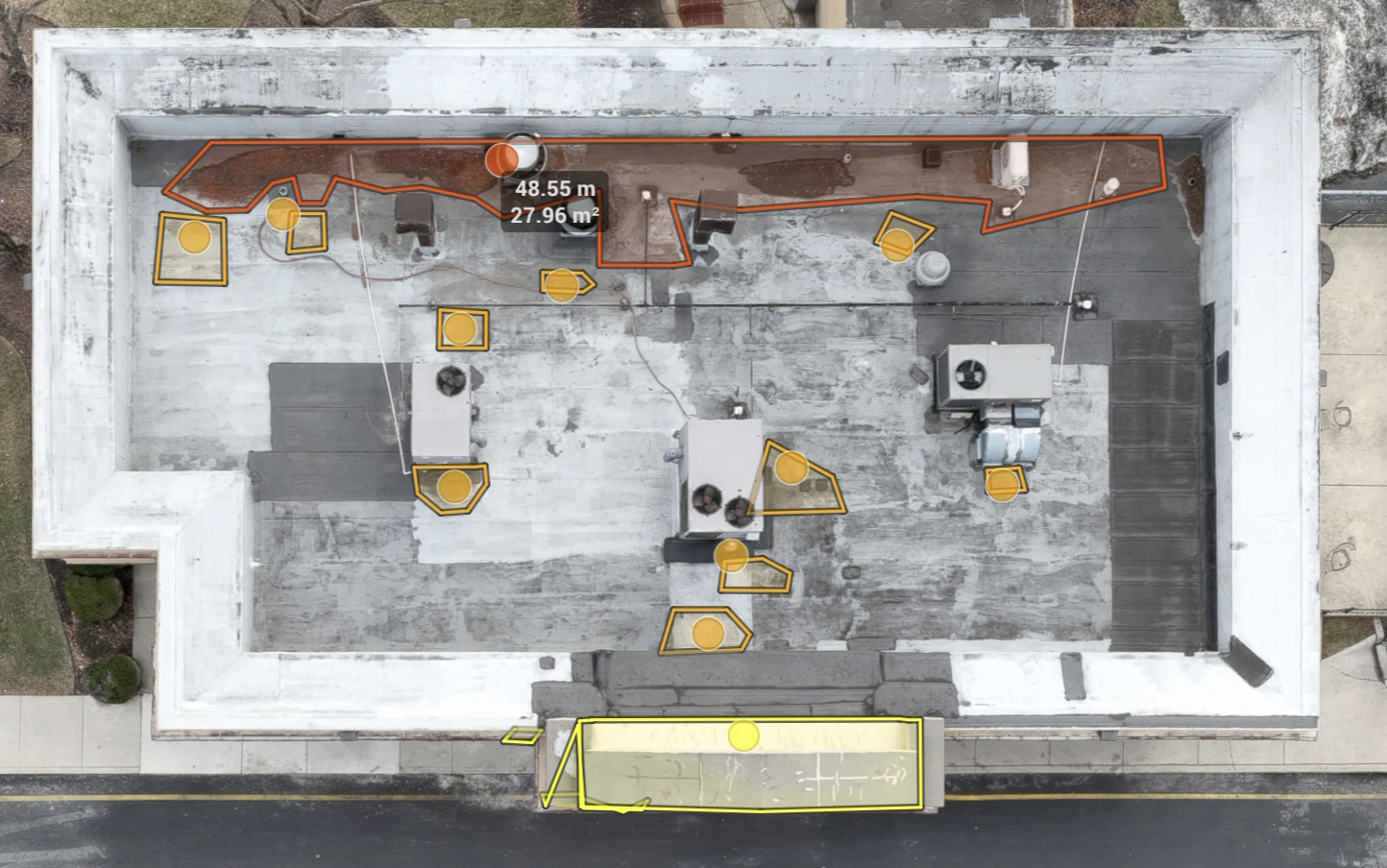 Annotated aerial visual capture of a commercial roof showing measured areas